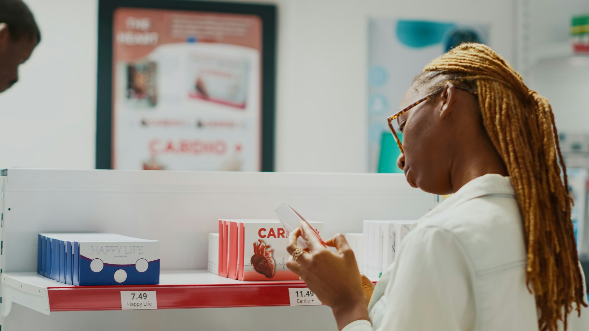 Female customer checking box of drugs in medical store